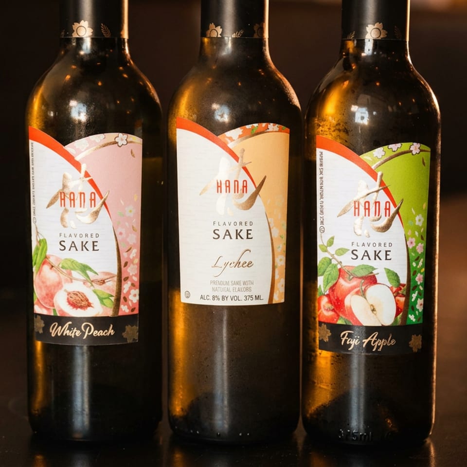 Three bottles of Hana flavored sake: White Peach, Lychee, and Fuji Apple.